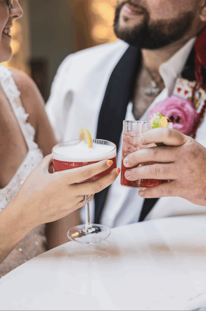 Bride and Groom Clinking Glasses together on their wedding day at the willows at ashcombe wedding venue